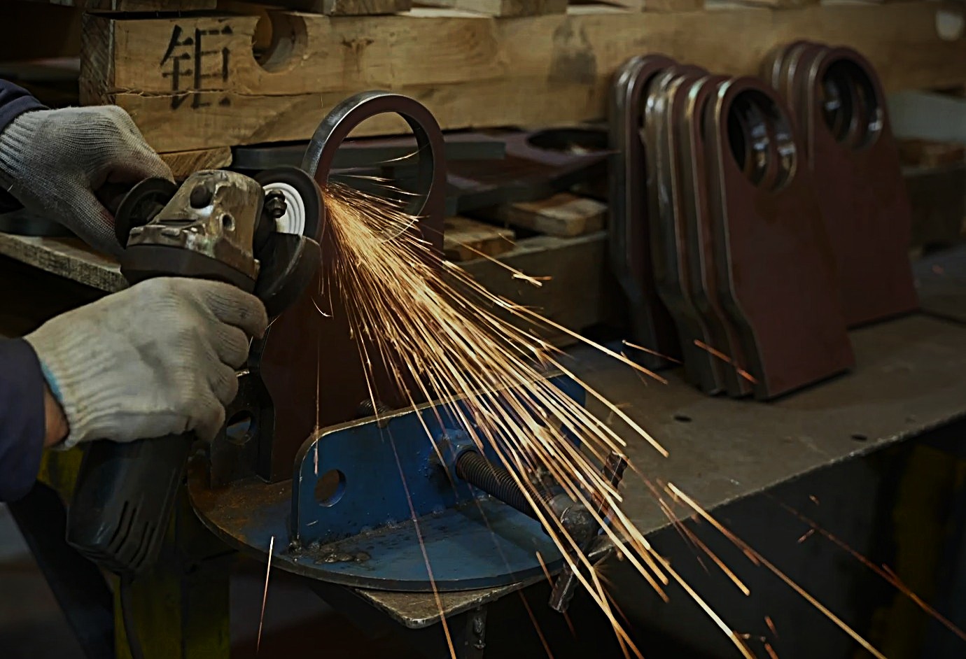 Deburring steel plate cut edges with grinding wheel